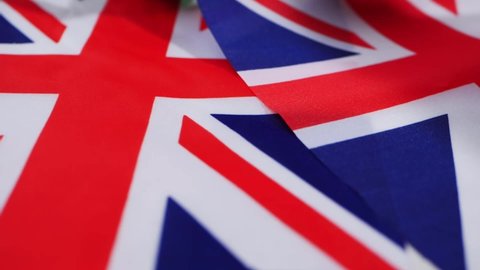 British Union Jack flag background close up overhead panning shot selective focus