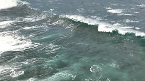 Slow motion drone video of ocean waves crashing the shore. Atlantic ocean
