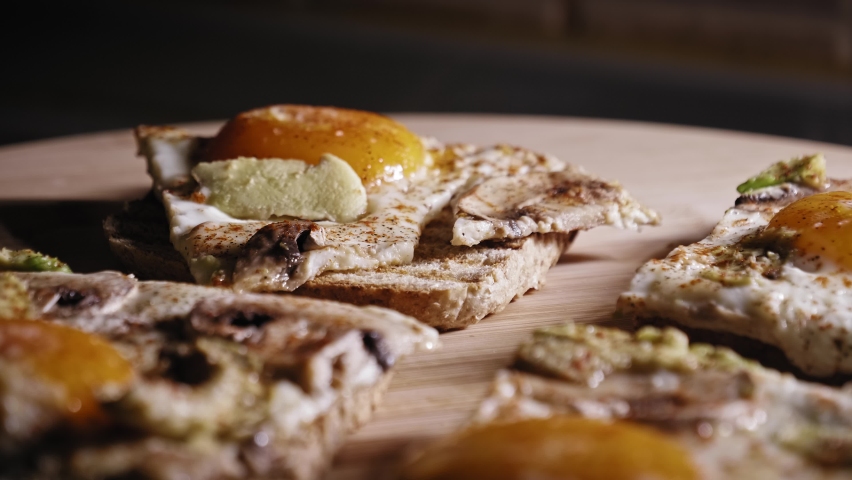 Freshly Cooked Food For Breakfast. Egg Toast With Mushrooms And Avocado, Seasoned With Salt And Pepper. close up, slider shot