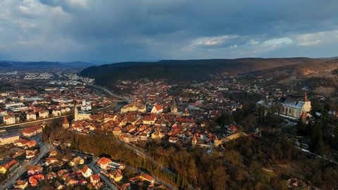 sunset in the historic medieval town of Sighisoara, aerial view of famous tourist destination in Romania, scenic unesco heritage site in Transylvania in winter. High quality 4k footage