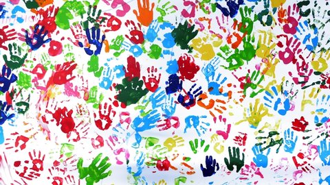 human colored palms. Colored handprints. close-up. art. many colored prints of human palms on a white background, on a white wall or canvas