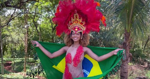 Carnival, beautiful woman, dressed for carnival party, in park, 4K, spinning, dancing and spinning, feeling of happiness, flag, flag of Brazil.