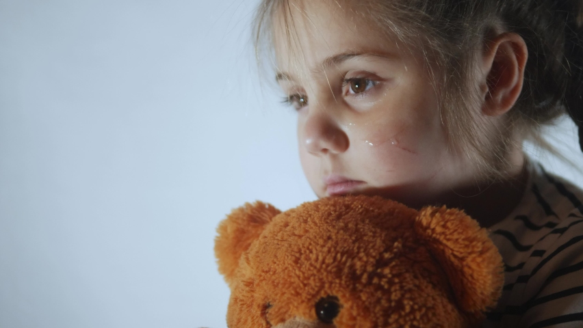 domestic violence autistic. little girl with bruises and abrasions on her face punished in the corner crying tears. domestic child abuse fear concept. child is punished and beaten afraid of fear Royalty-Free Stock Footage #1088230115