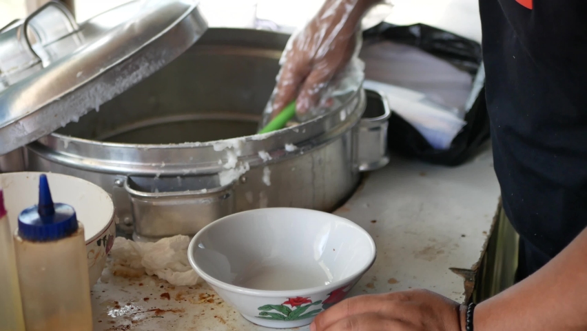 Chicken porridge seller is preparing customer orders