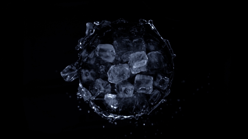 Super slow motion shot of rotating exploded Ice Cubes and splashing water on black at 1000fps. Royalty-Free Stock Footage #1088232455