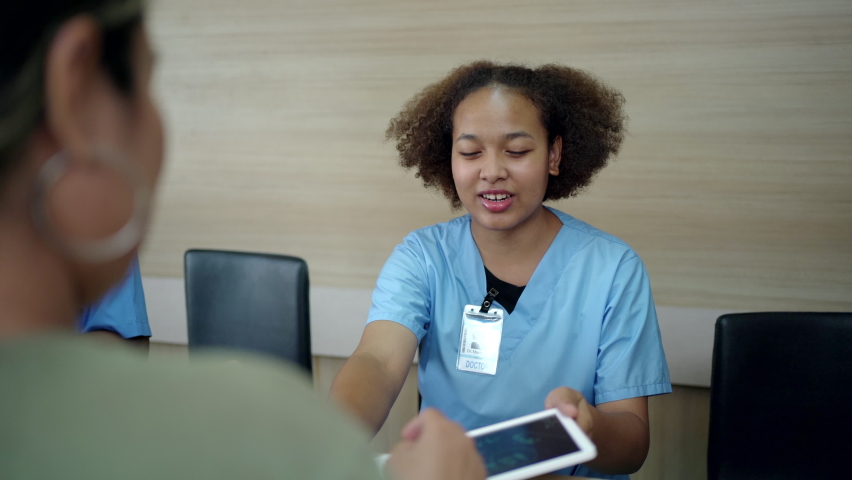 People making an appointment with medical staffs at reception desk in hospital. Medical staff and nurse - receptionist talking to patient in front of the reception counter in hospital. | Shutterstock HD Video #1088233117