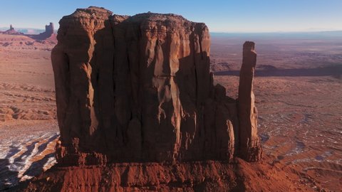 Drone flying close at red Monument valley rock formations in Navajo land Utah Arizona landmark USA. 4K aerial view of famous Wild West nature park. Wild West landscape from western movies with cowboys