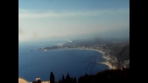 taormina, italy june 29 1970:Sunny morning view of Taormina town and Etna volcano on background.