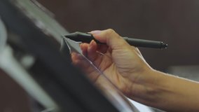 The designer draws on a graphics tablet. Working with interactive pen display. Drawing on a graphics tablet. closeup. Wallpaper production. - Powered by Shutterstock - Get 15% off with code: PIKWIZARD15