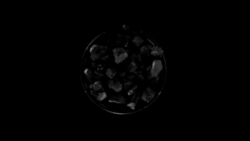 Super slow motion of rotating coal pieces on black background. Filmed on high speed cinema camera, 1000fps. Royalty-Free Stock Footage #1088238937
