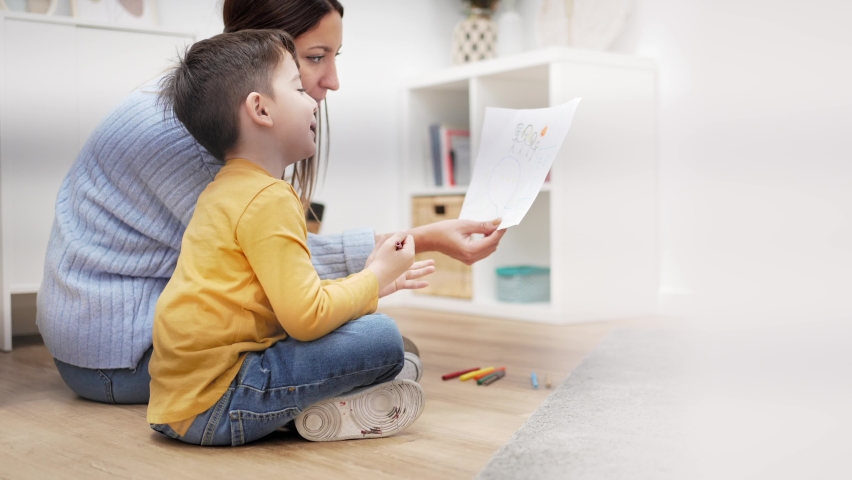Child Therapist helping kid to understand family problem using drawing picture of his parents. Children mental health therapy | Shutterstock HD Video #1088240257
