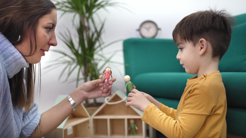 Children therapy with games. Young female therapist playing with toy to help autist child to improve his behavior and mental health Royalty-Free Stock Footage #1088240263