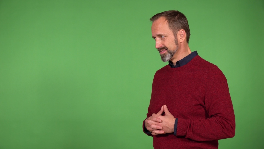 A middle-aged handsome Caucasian man shows a double thumb up to the camera with a smile - green screen background Royalty-Free Stock Footage #1088240743