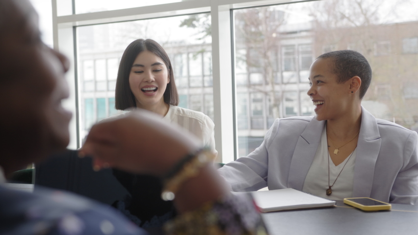 Slow motion of mixed race and Chinese businesswomen discussing and laughing in business meeting with colleagues | Shutterstock HD Video #1088242905