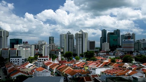 Singapore, Singapore  Singapore - 02 25 2022: Time lapse of the skyline of Singapore with the Little India area shophouses in the foreground