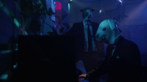 Weird party, creepy people in a night club. Man in an rabbit mask playing piano, madness, drugs. Uneasyness, scary scene. Secrets and mystery, night disco scene with masked, weird people.
