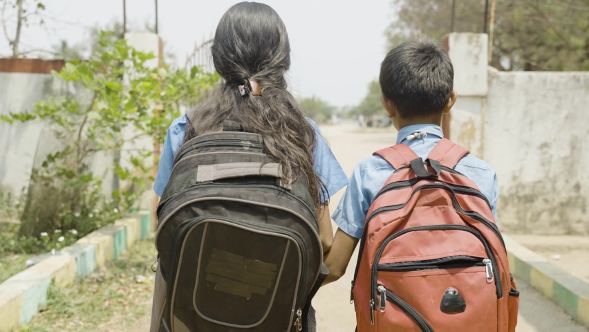 Back view tracking shot of kids in unifrom going home from school - concept of happiness, friendship and education Royalty-Free Stock Footage #1088246007