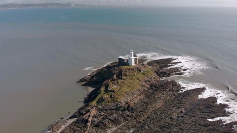 aerial approach to mumbles lighthouse in swansea bay south wales