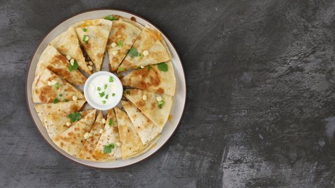 Serving a Beef Quesadilla with Sour Cream Shot from Above
