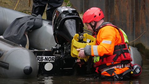 Norwich, Norfolk, United Kingdom. February 19, 2021. Norfolk Fire and Rescue Service Urban Search and Rescue surface rescue boat crew attend outboard engine.