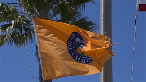 County or Orange California flag flapping in the wind. Slowed to quarter speed.