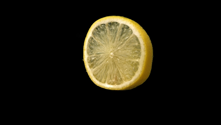 Lemon slice rotating in front of blank background