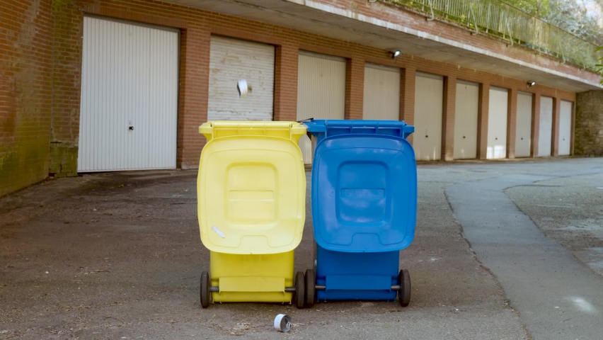 Trash falling and spilling out over garbage cans - Slow motion