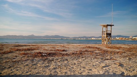 Sunny beach in Mallorca - el Arenal overlooking the Palma bay. It contains a watchtower and some light clouds with blue sky