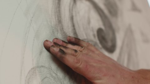 Close up artist hand drawing by fingers, shading graphite on canvas, creating masterpiece by arm. ProRes codec