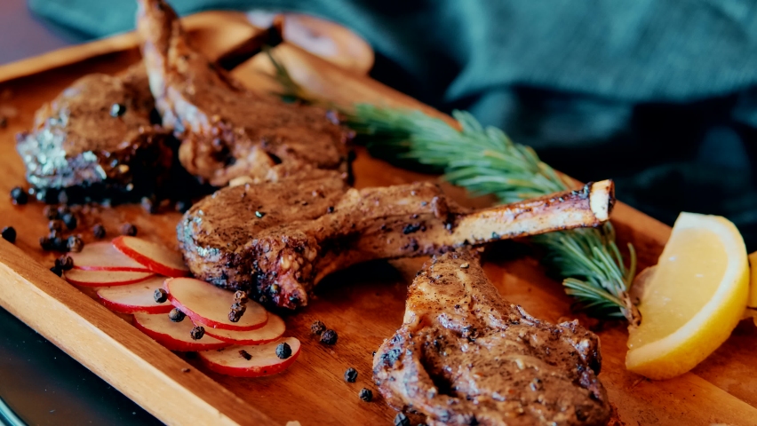Grilled Lamb Chops with Rosemary and vegetables. Roasted Cutlets on Creative Restaurant Backdrop. Mutton Ribs with Spices and Sauce Royalty-Free Stock Footage #1088263151