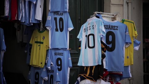 Montevideo, Uruguay - May 2015: Clothes Market Stall with Argentina, Uruguay and Brazil National Football Team Jerseys. 4K Resolution.
