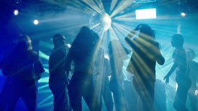Youth enjoying weekend evening at disco. Dancing under abstract light effects. Nightlife, modern music and entertainment concept. - Powered by Shutterstock - Get 15% off with code: PIKWIZARD15