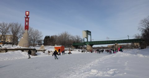 Winnipeg, MB, Canada - March 2022: People skating over the frozen Assiniboine River