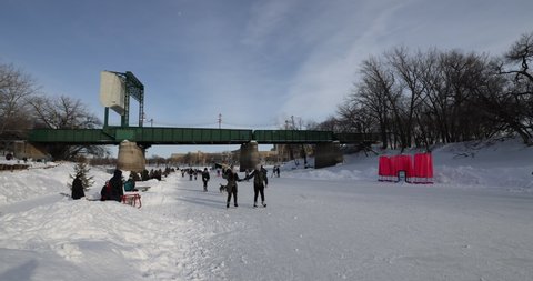 Winnipeg, MB, Canada - March 2022: People skating over the frozen Assiniboine River