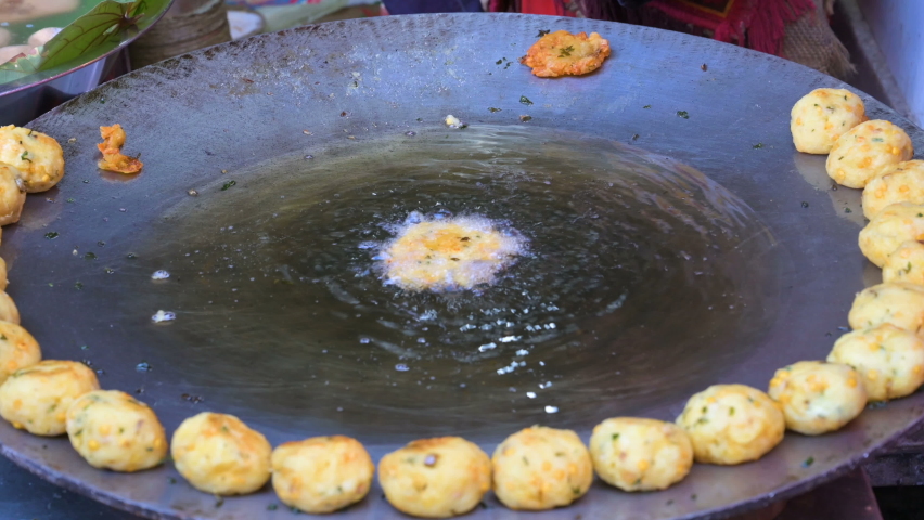 Aloo tikki, aloo ki tikki or aloo tikia is a Indian steet food made of smashed potatoes, delicious and popular vegeterian fast food in India. 4k video of making aloo tikki on kadai, for cooking.
