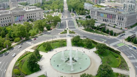 Low Angle Drone Shot of People Enjoying the Logan Square Fountain in Philadelphia on a Sunny Summer Day