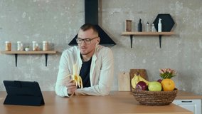 Caucasian businessman talking to his colleagues about a business by a video conference. Eating banana. For lifestyle design. Internet technology. Video