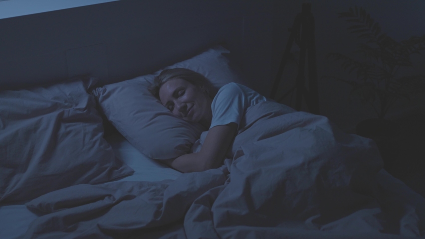 The woman sleeps in her bed. Restful sleep is essential for recuperation. Royalty-Free Stock Footage #1088272615