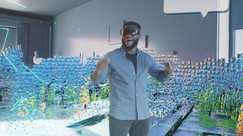 African American man putting on VR headset and looking around with smile while exploring futuristic cyberspace of metaverse in living room at home