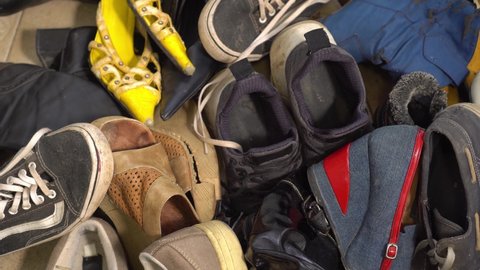 Old used shoes. Disposal, recycling concept, donation charity second hand. Fashion and Textile Waste