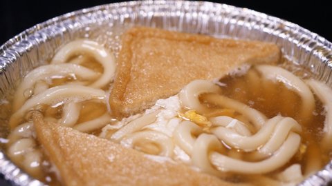A video of Kitsune Udon. Udon with fried tofu. Kakiage tempura and shrimp tempura.