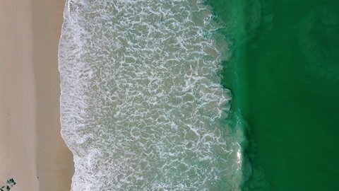 Professional video Nature video 4K Aerial view of drone. Scene of top view beach and seawater on beach in summer. Nature and travel concept.