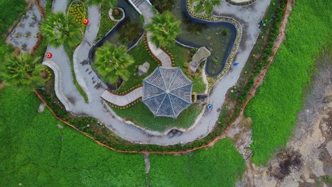 Drone 4k footage of a chinese themed public park in Lima, Peru. In Miraflores. The clip consists of a topdown shot of a pergola, slowly flying up.