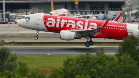 PHUKET, THAILAND - DECEMBER 02, 2016: Airbus A320, HS-BBC of AirAsia braking after landing at Phuket Airport (HKT). AirAsia Malaysian low cost airline. Tourism and travel concept