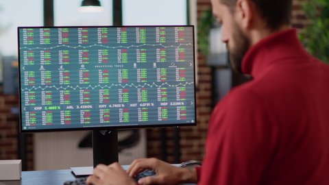 Young investor working on computer with real time stock charts, following trade market sales trend. Financial analyst using forex exchange statistics to plan data analysis, index profit. Close up.