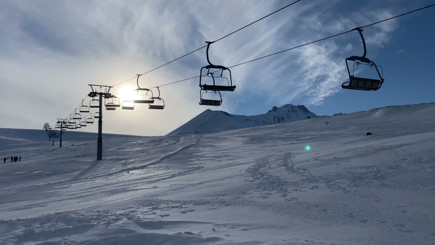 Ski lift (Chair lift). Erciyes mountain and skiing center in Kayseri. Winter sports and recreation, leisure outdoor activities. Royalty-Free Stock Footage #1088284417