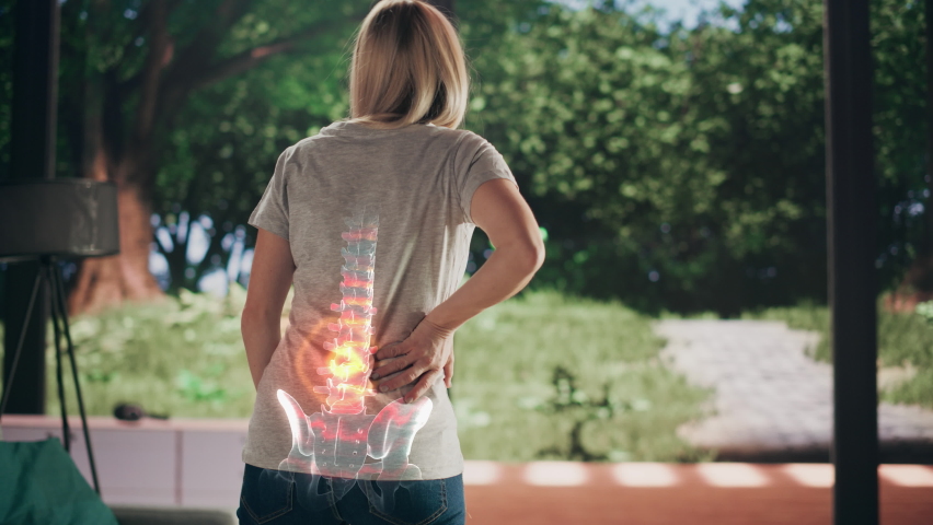 VFX Back Pain Augmented Reality Animation. Close Up of a Female Experiencing Discomfort in a Result of Spine Trauma or Arthritis. Massaging and Stretching the Back to Ease the Injury. | Shutterstock HD Video #1088284775