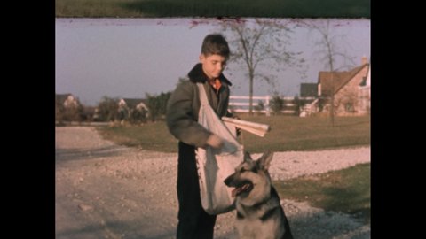 1940s: Neighborhood. Paperboy pets dog. Boy walks dog down street. Hand holds pocket watch. Boy sits at table.