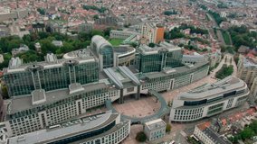 Top View of European Parliament Building in Brussels, Capital of Belgium, EU. Aerial Panorama of Modern Glass Building as Politics Power Landmark. 4K establishing drone orbit shot - Powered by Shutterstock - Get 15% off with code: PIKWIZARD15