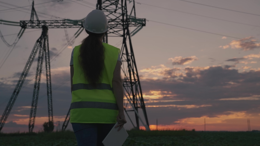 woman power engineer helmet with tablet her hands works. governing body of electricity industry. electrical engineer job concept. young female electrician network repairman. electric tower business. Royalty-Free Stock Footage #1088287261